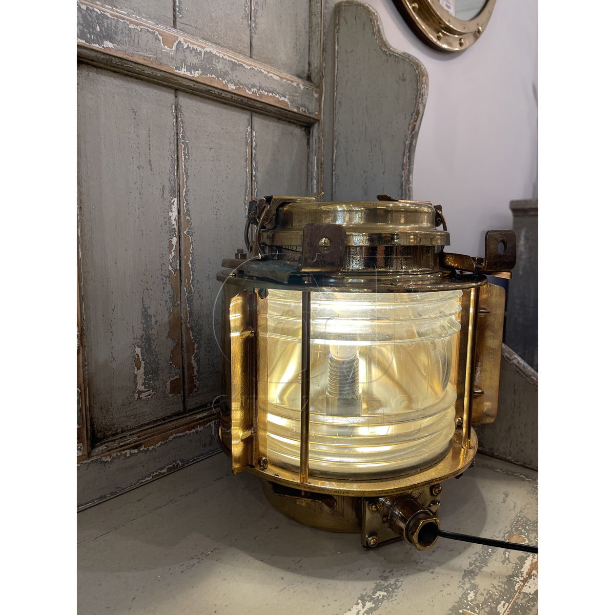 Salvaged brass marine bulls eye light with thick lens