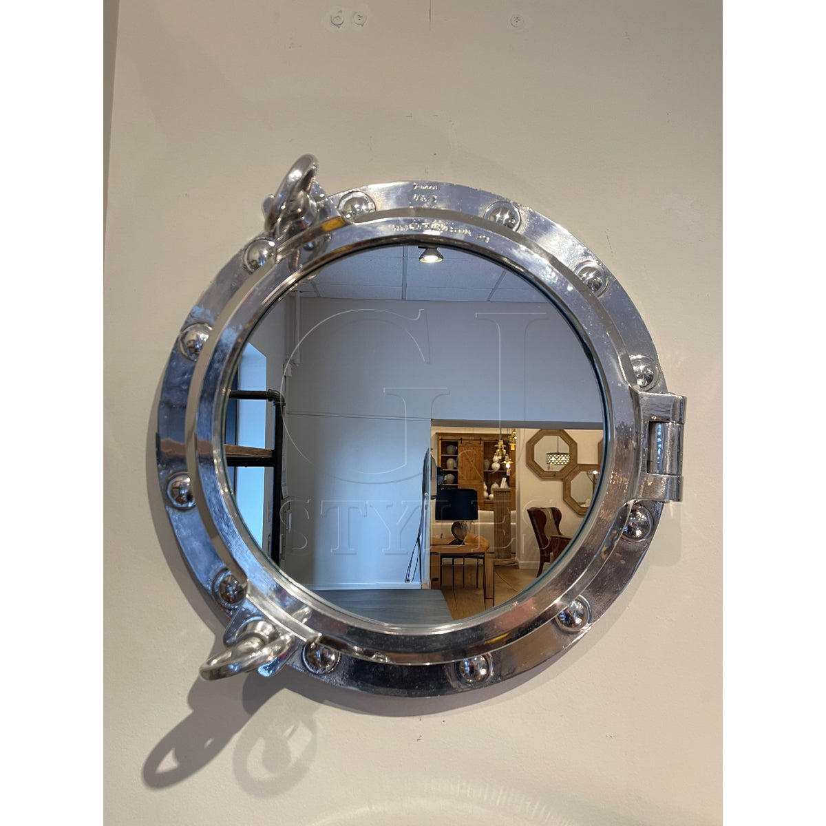 Mirror in a round salvaged aluminum opening ship porthole