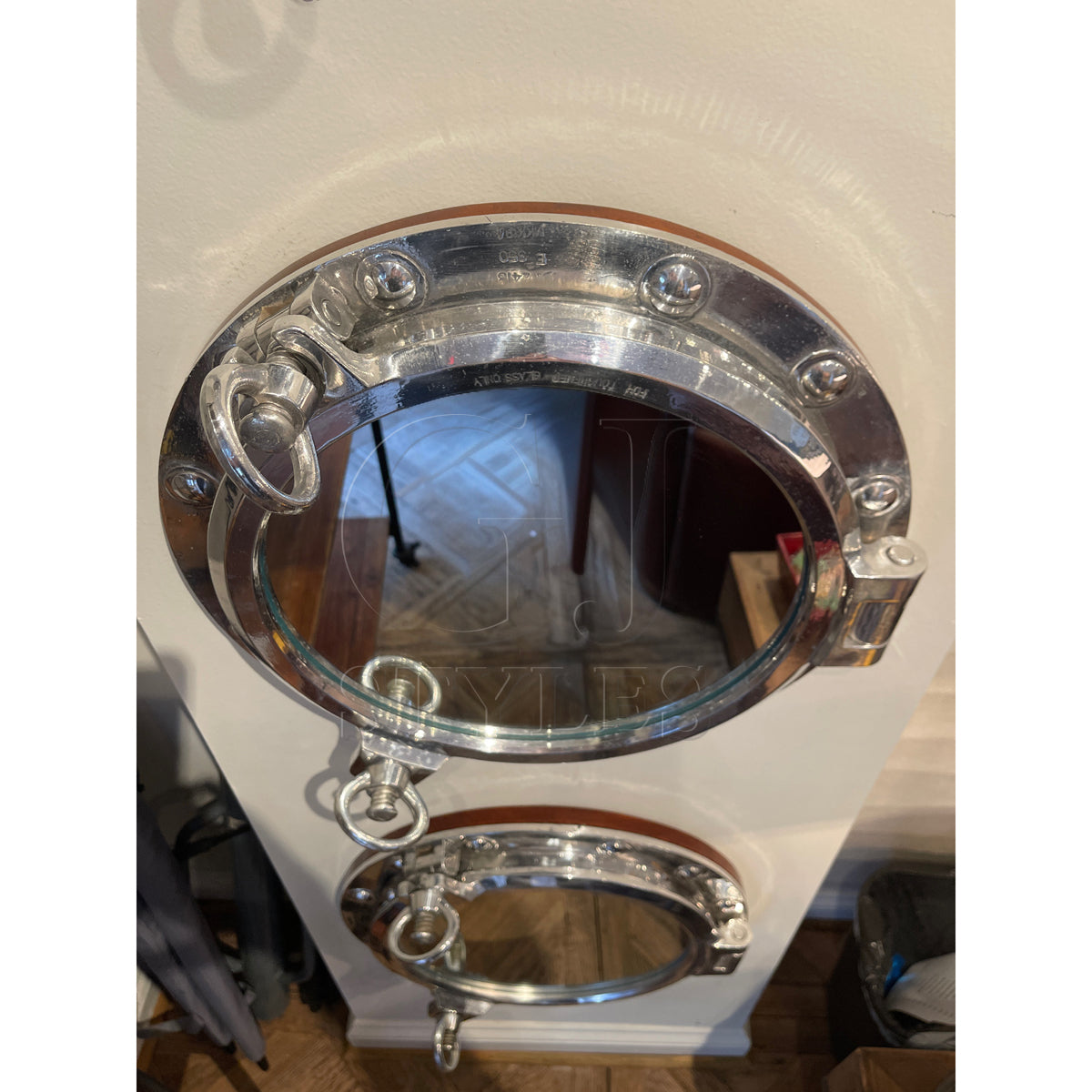 Mirror in a round salvaged aluminum opening ship porthole