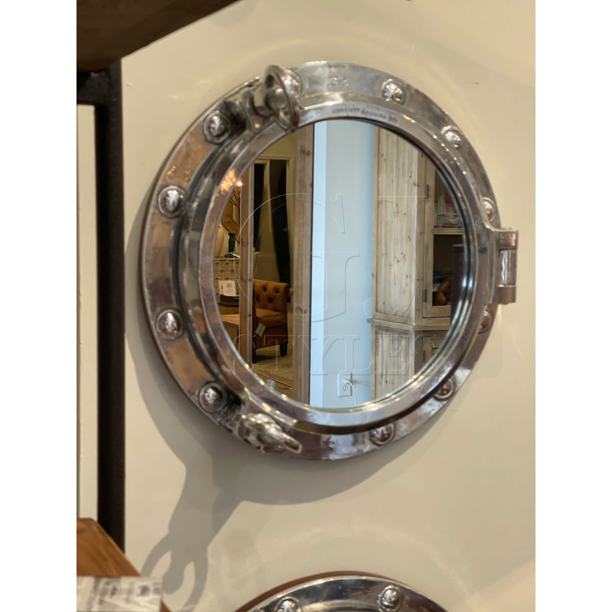 Mirror in a round salvaged aluminum opening ship porthole