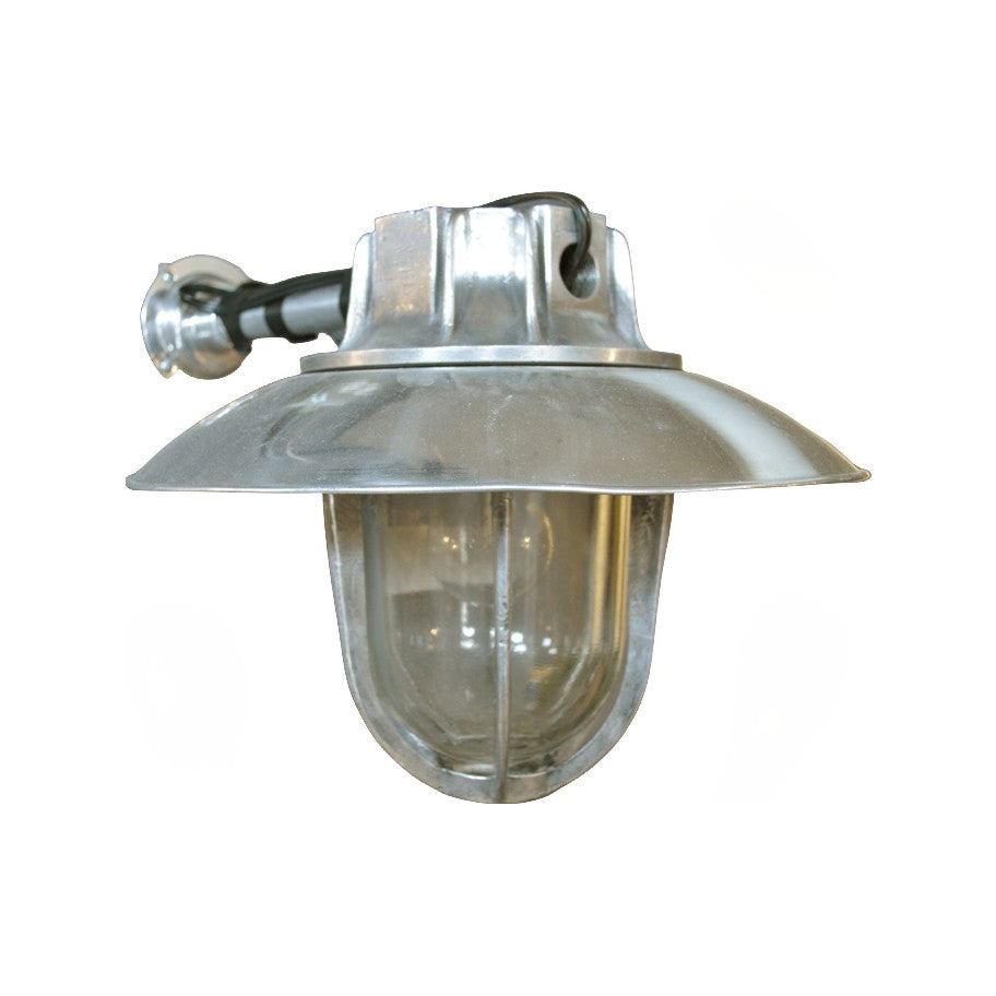 Salvaged Italian industrial wall light with metal arm and protective glass lens
