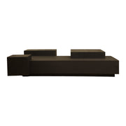 Low black oak coffee table with stacked, layered volumes