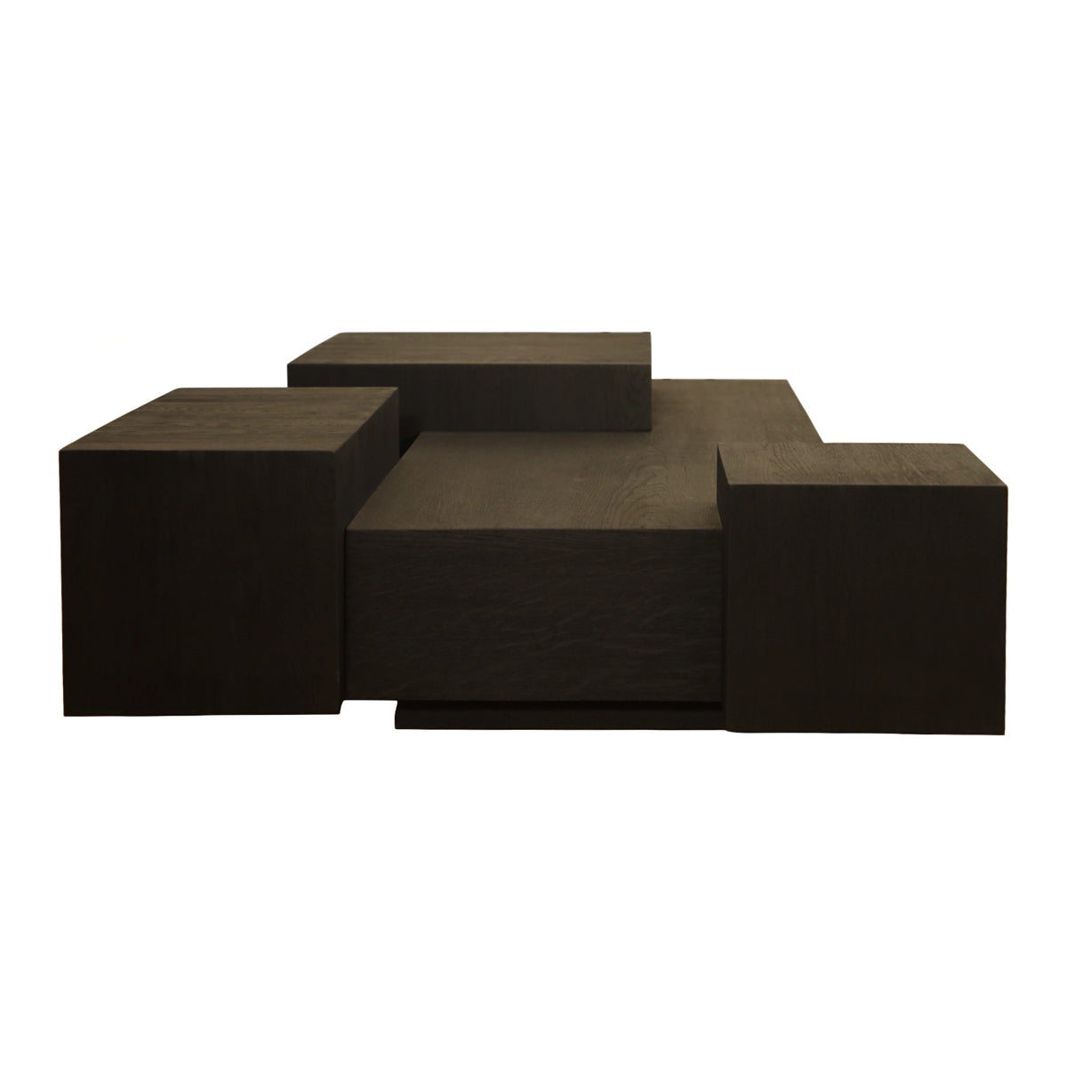 Low black oak coffee table with stacked, layered volumes