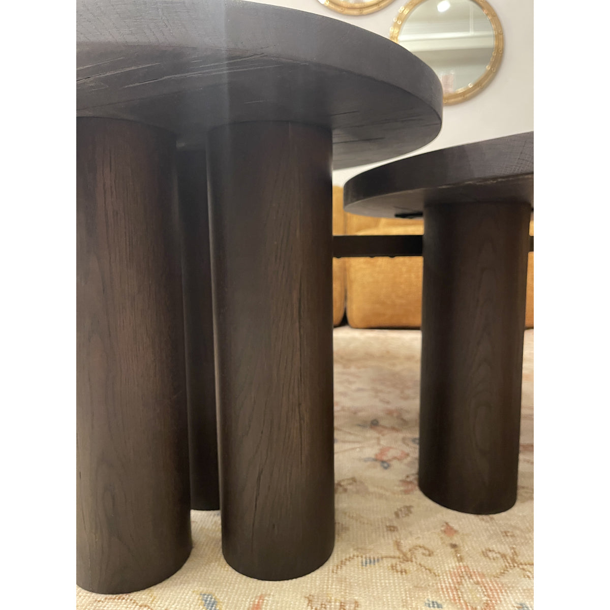 Black oak coffee table set with rounded tops and cylindrical supports