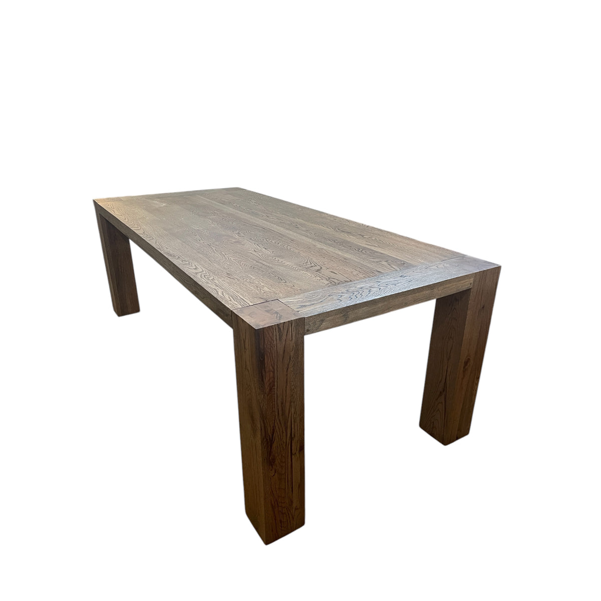 Oak dining table with chestnut detailing on a rectilinear base