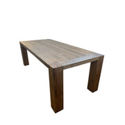 Oak dining table with chestnut detailing on a rectilinear base