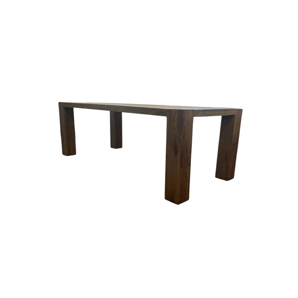 Oak dining table with chestnut detailing on a rectilinear base