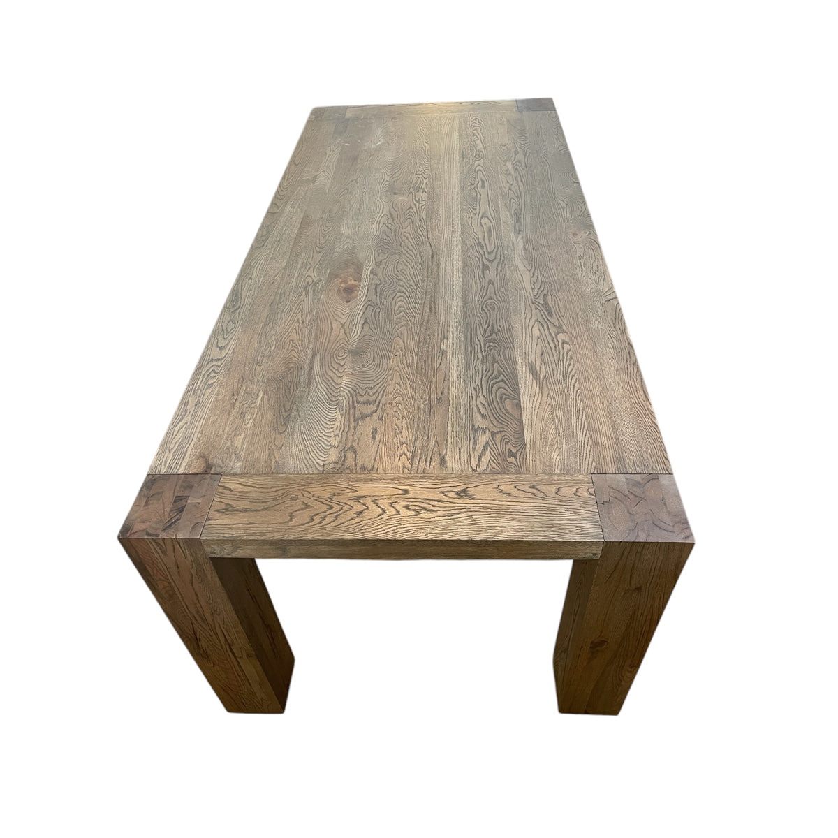 Oak dining table with chestnut detailing on a rectilinear base