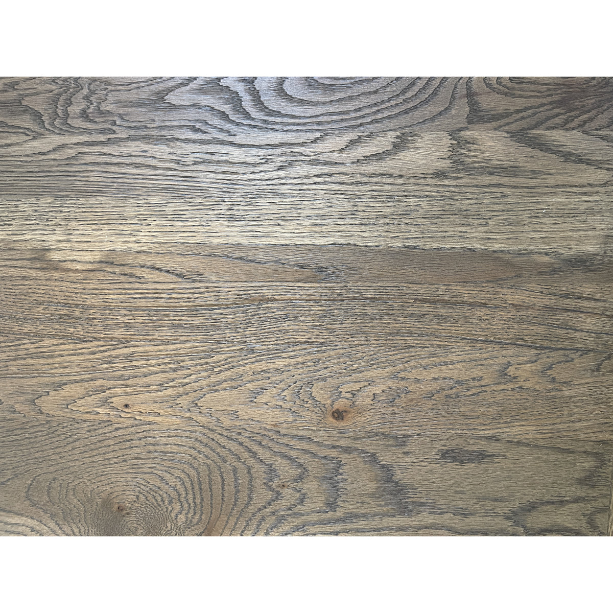 Oak dining table with chestnut detailing on a rectilinear base