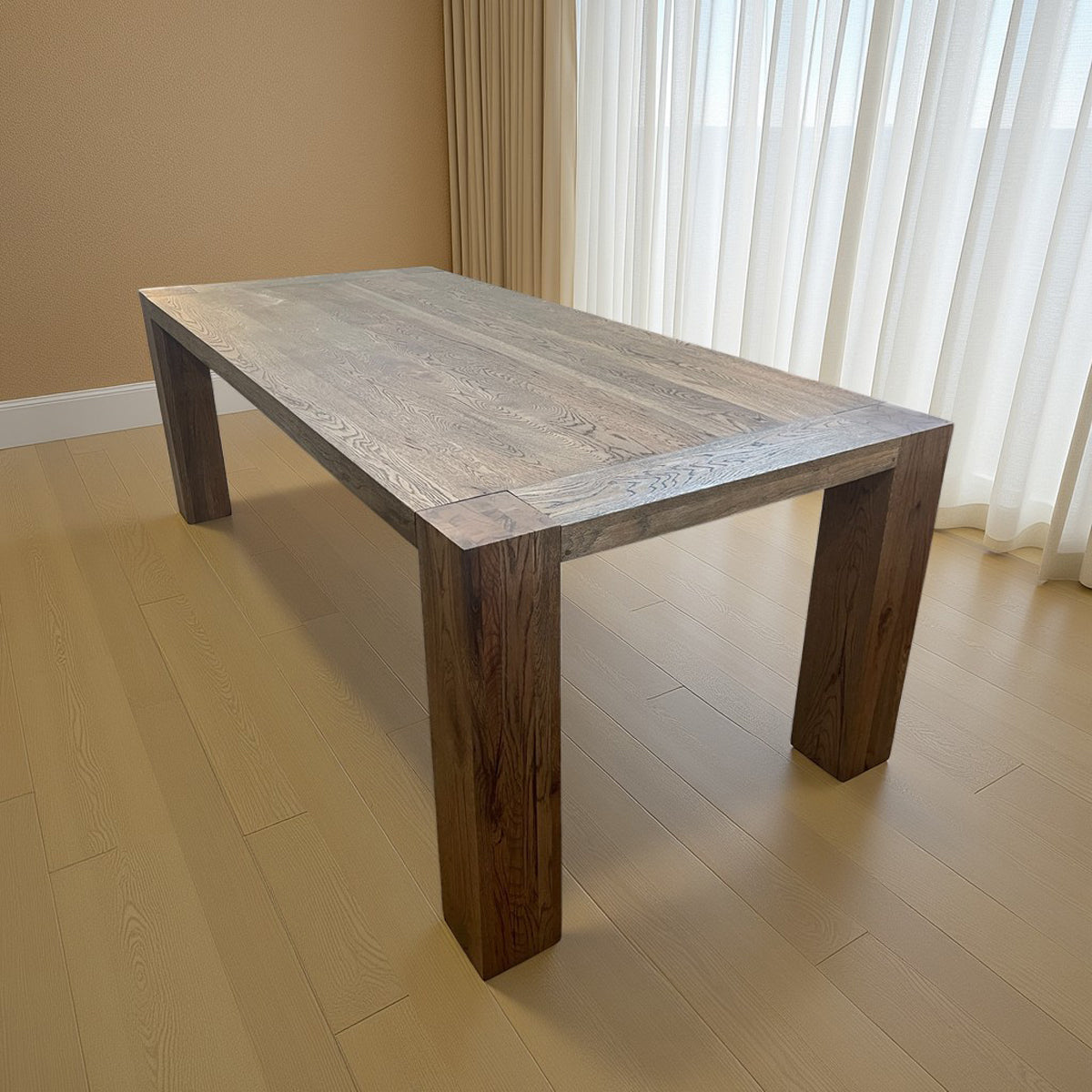 Oak dining table with chestnut detailing on a rectilinear base