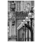 Black and white photograph of historic street lanterns along a facade