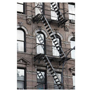 Photograph of a New York City fire escape on a brick facade, on metal