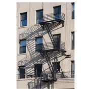 Photograph of a New York City fire escape zigzagging up a masonry facade