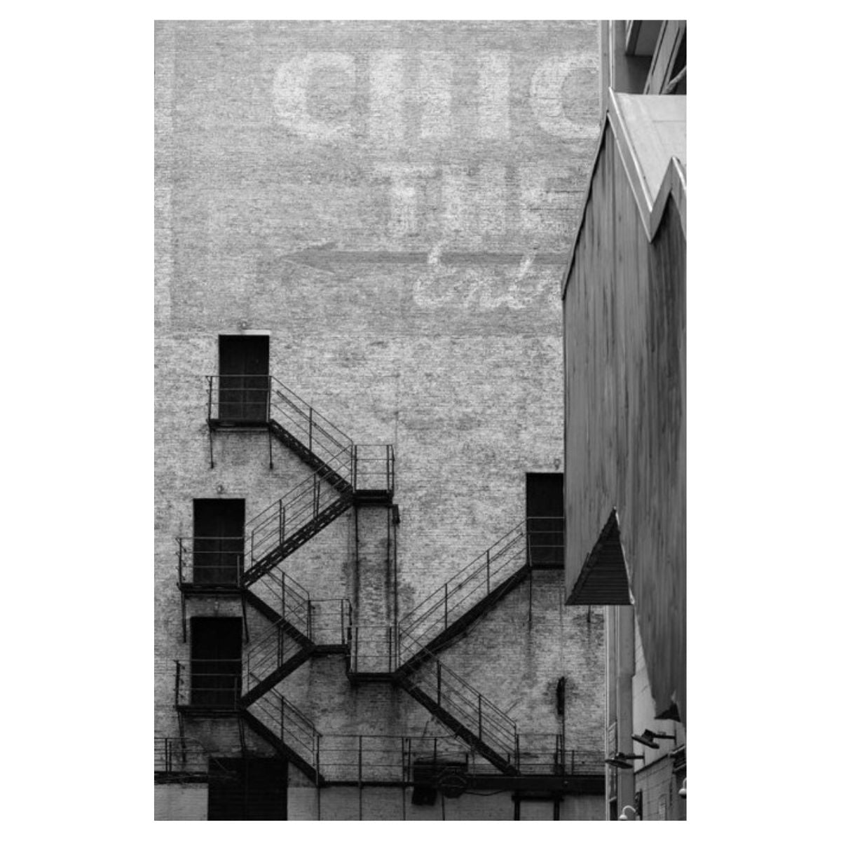 Black and white photograph of a fire escape on a Chicago brick facade