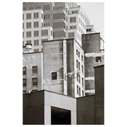 Monochrome photograph of layered old and new city building facades
