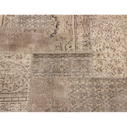 Vintage Turkish patchwork rug in muted, evenly faded wool tones.