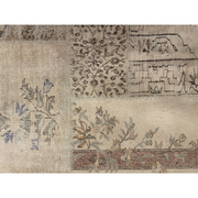 Vintage Turkish patchwork rug with pale floral and geometric remnants.