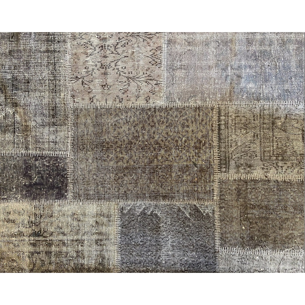 Vintage Turkish patchwork rug in soft, muted wool tones.