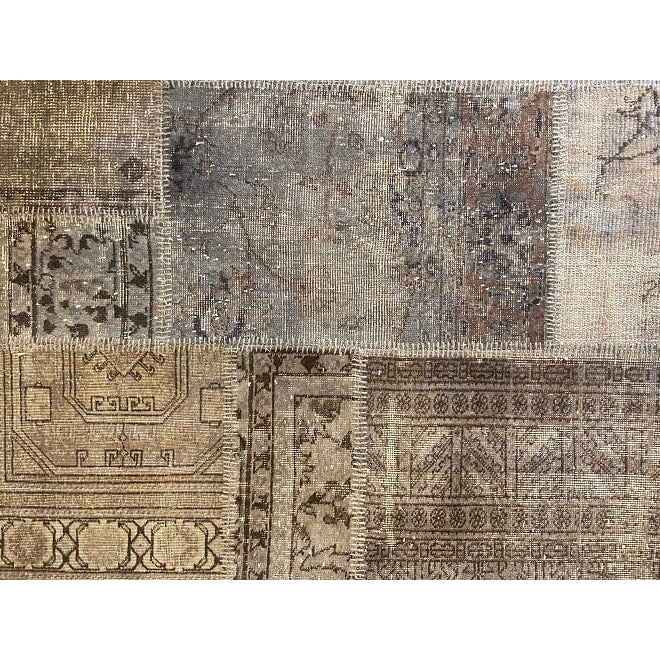 Vintage Turkish patchwork rug in muted blue-grey wool tones.