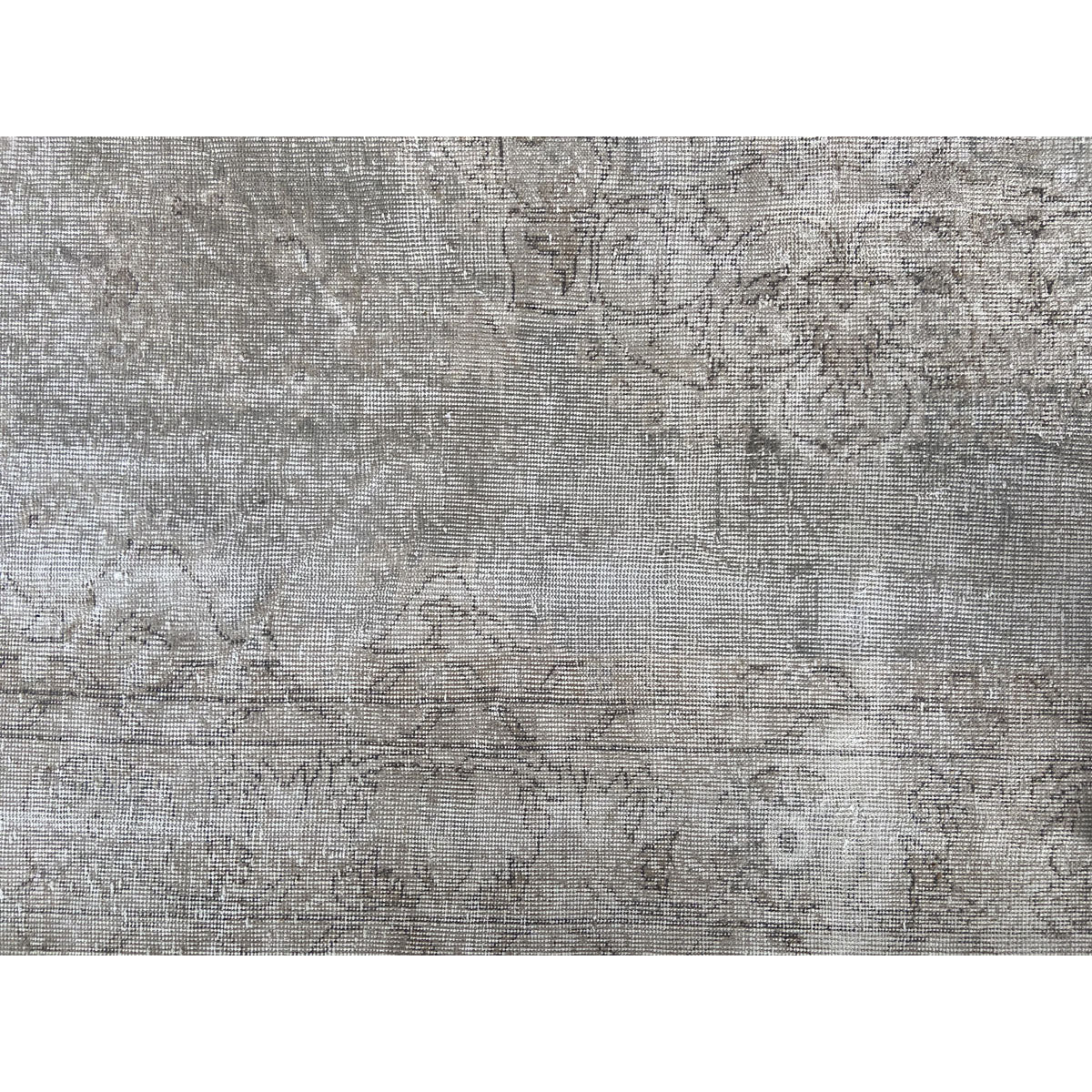 Heavily worn handwoven Turkish wool rug in cool, faded tones.