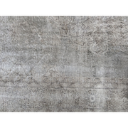 Heavily worn handwoven Turkish wool rug in cool, faded tones.