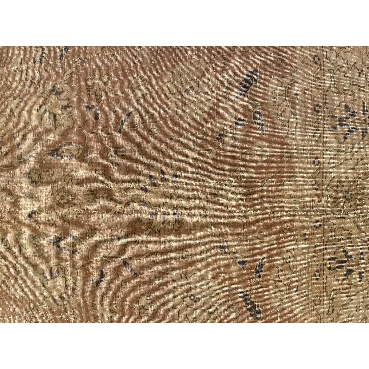 Softly worn handwoven Turkish wool rug in warm, subdued tones.