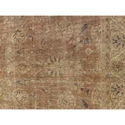 Softly worn handwoven Turkish wool rug in warm, subdued tones.